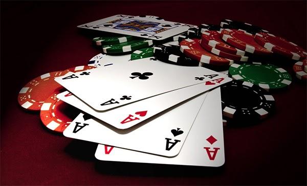 A close-up of poker chips and cards

Description automatically generated